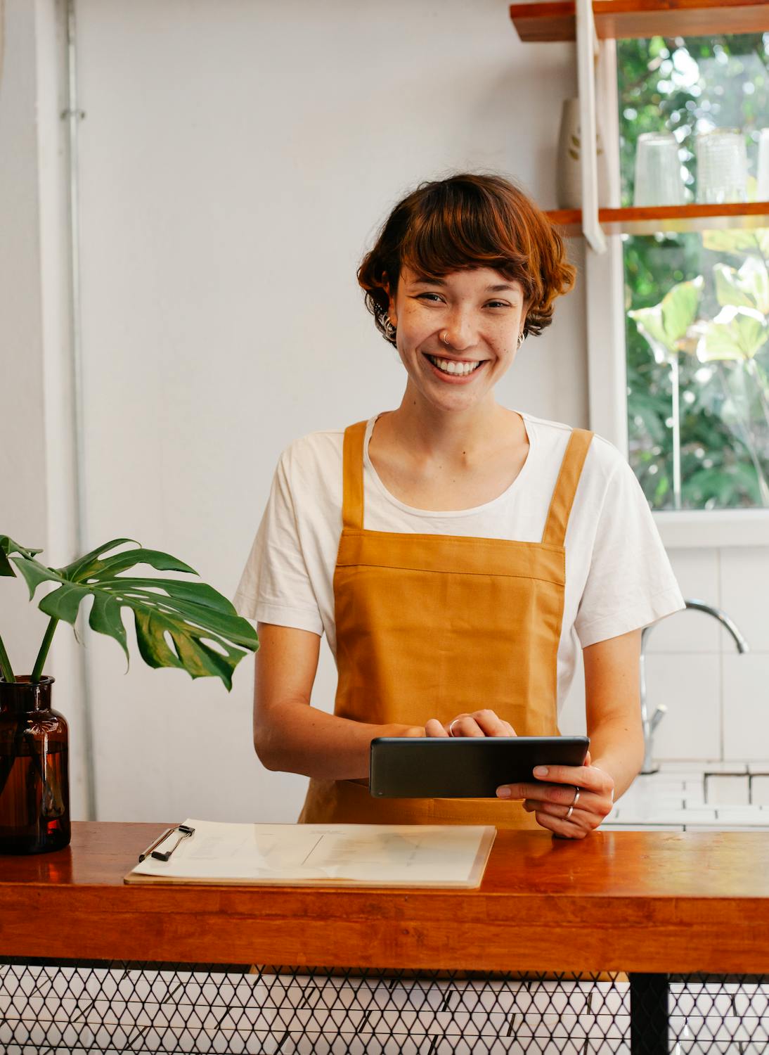 Cheerful employee at cafe counter